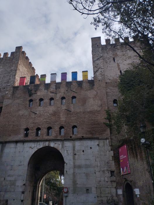 The towers of Porta San Sebastiano with coloured elements along the battlements