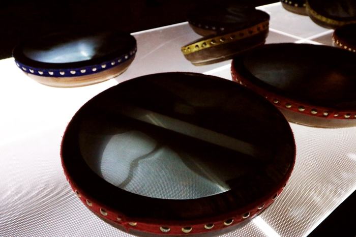 Close view of frame drums with X-ray film skins on an illuminated table