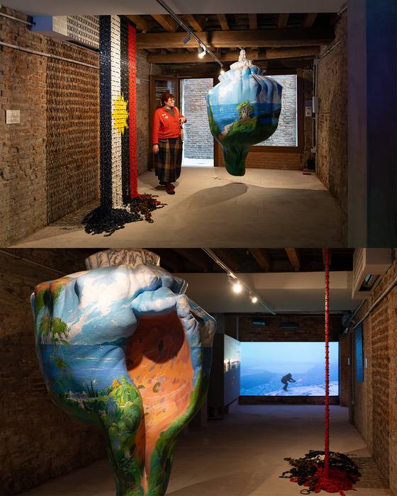 Two views: a visitor beside the chain curtain and the shell sculpture; a close-up of the shell sculpture in a corridor with a video screen